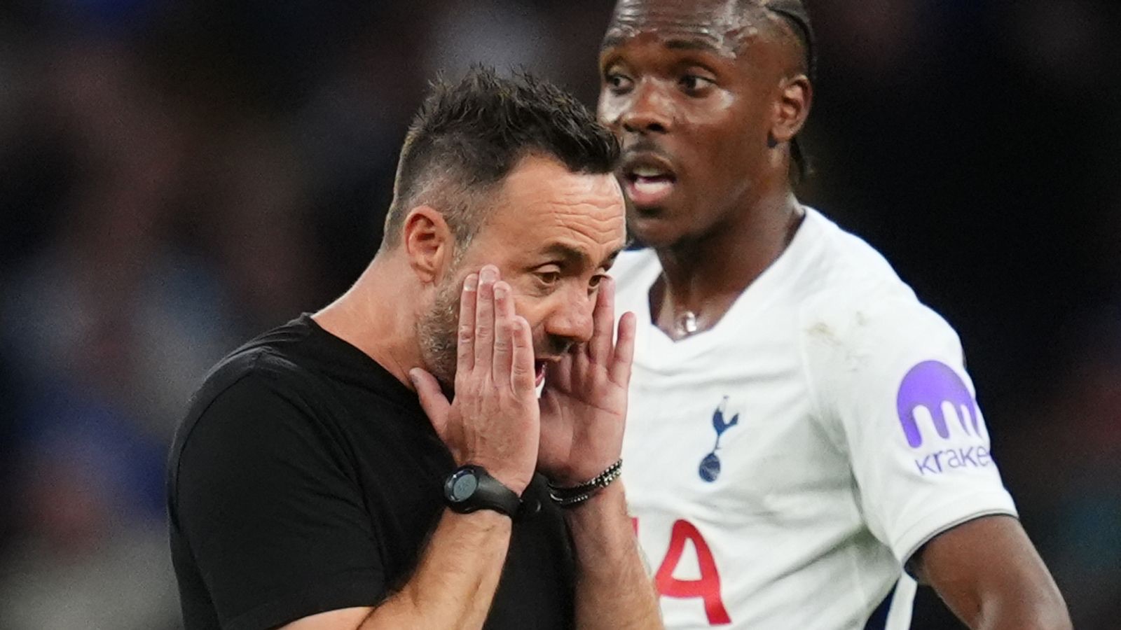 Roberto De Zerbi holds his face on the touchline at Spurs