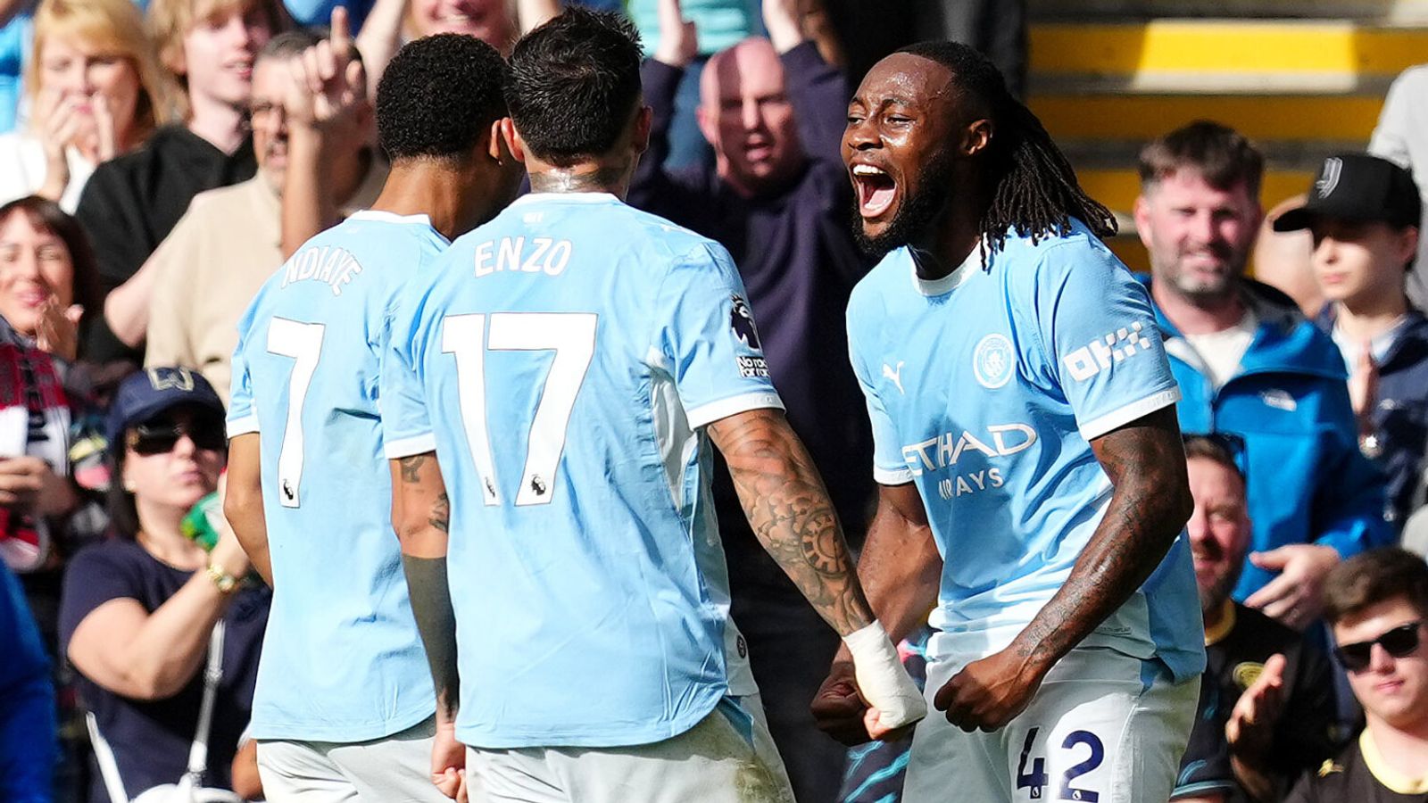 Manchester City players including Enzo and Ndiaye celebrate in front of the crowd